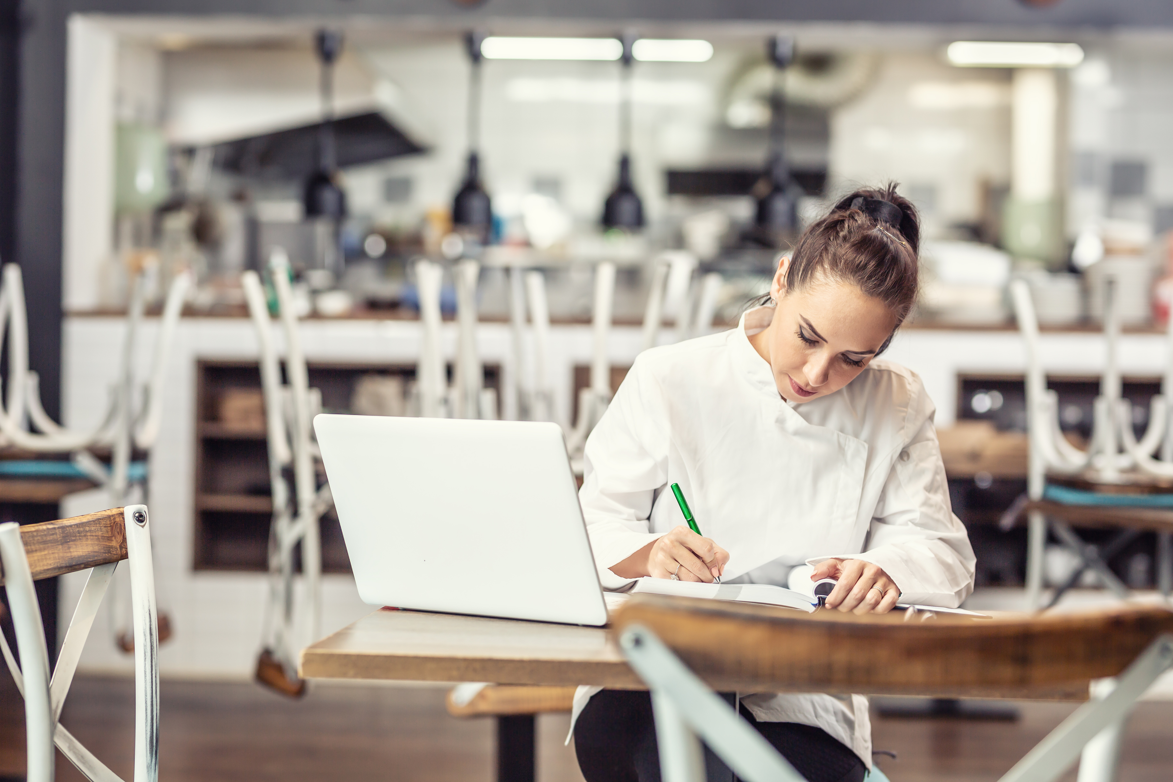 Woman at a desk in front of a laptop computer